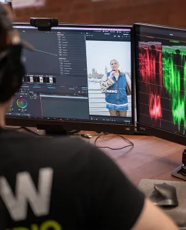 Unit Studio editor colour grading a video clip across two monitors