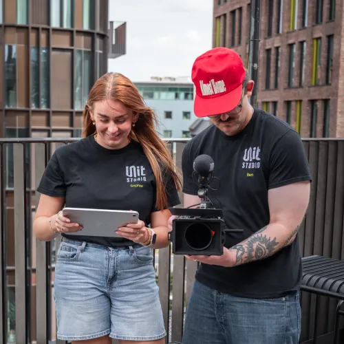 Sophie and Ben reviewing shots on location during a photography shoot