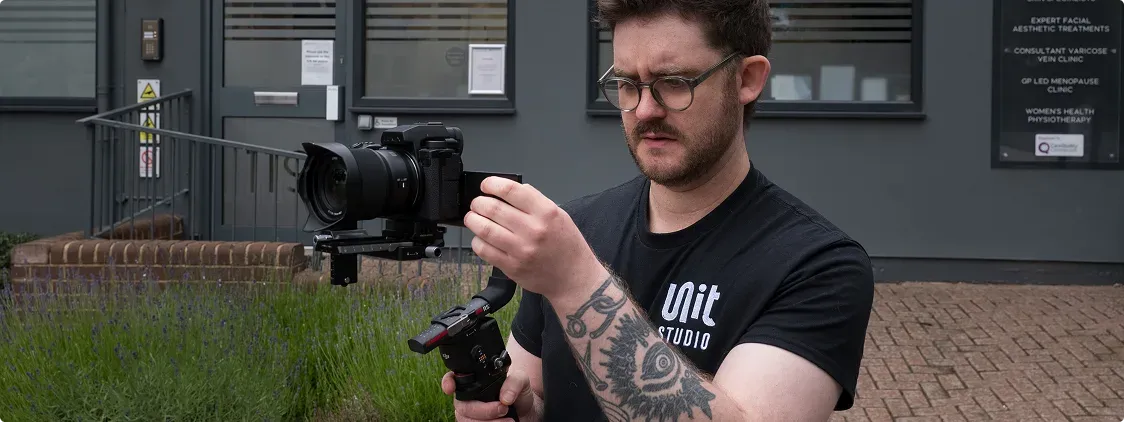 Unit Studio videographer filming with a camera rig on location